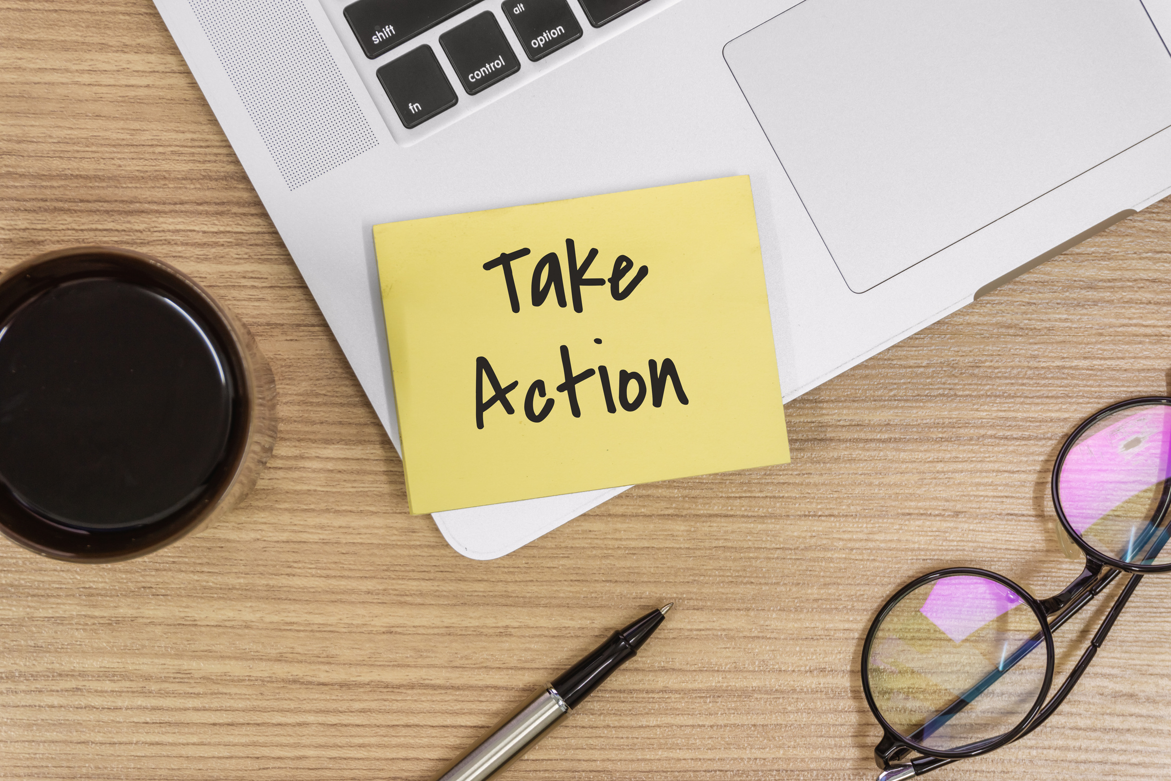 Take Action. Sticky Note and Laptop on Wooden Work Desk